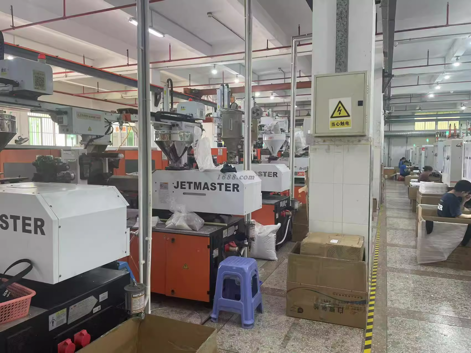 Workers assembling Bluetooth earphones on production line